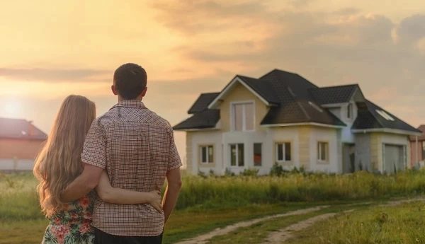 couple looking on house